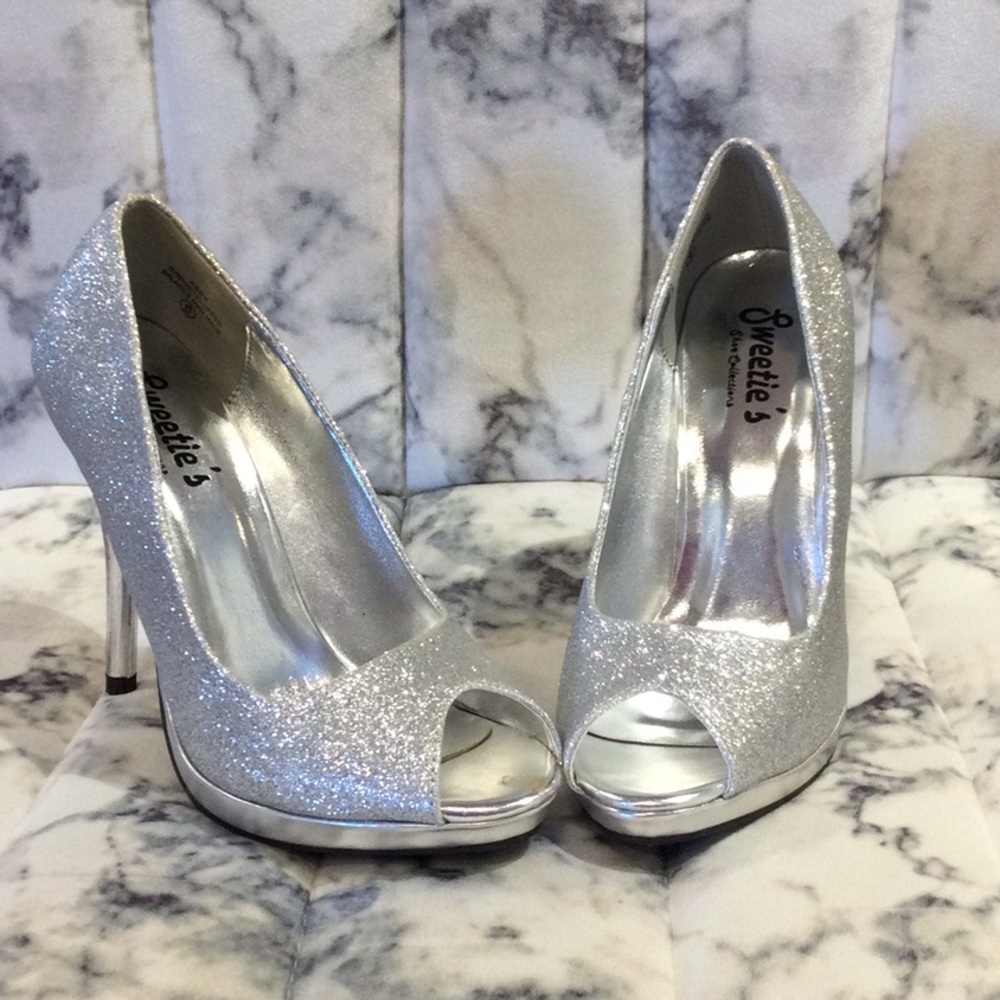 Silver 4 1/2 inch heels with an open toe